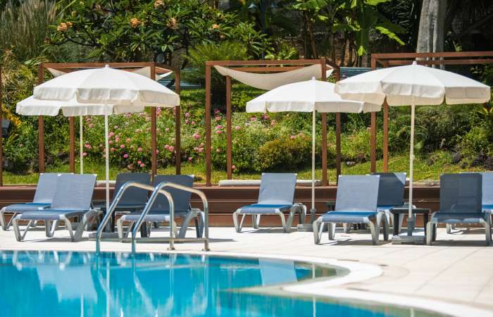 Pool med solstole og parasoller 